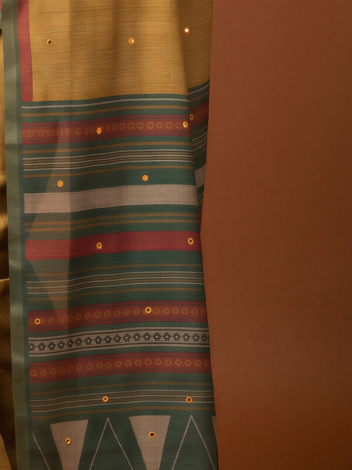 Pallu detail of mustard linen blend saree showing traditional indian motif work and printed border