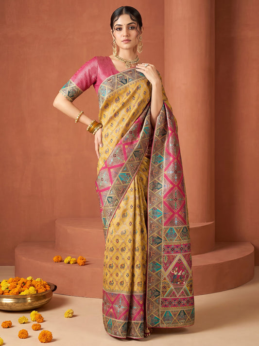 Woman wearing mustard viscose silk saree with traditional indian motif work and pink blouse