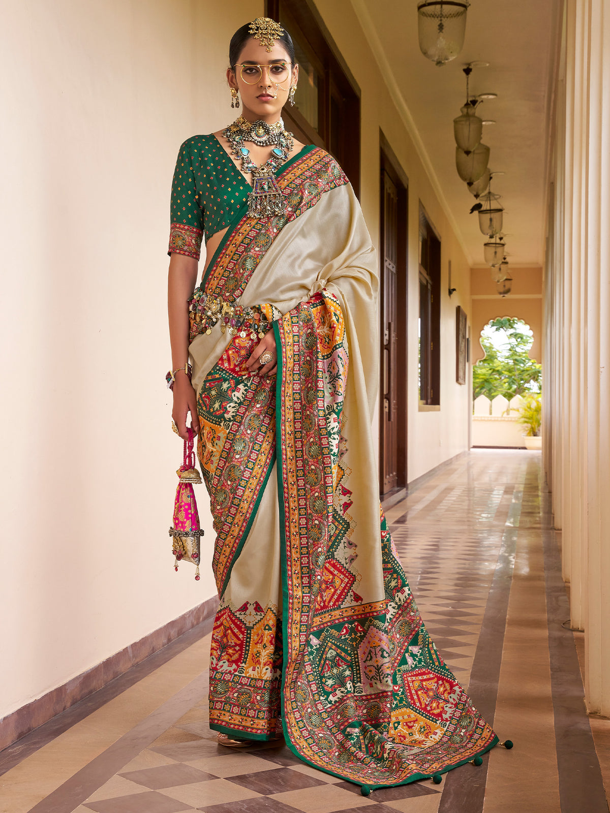Woman wearing beige silk blend saree with traditional indian motif work and green blouse