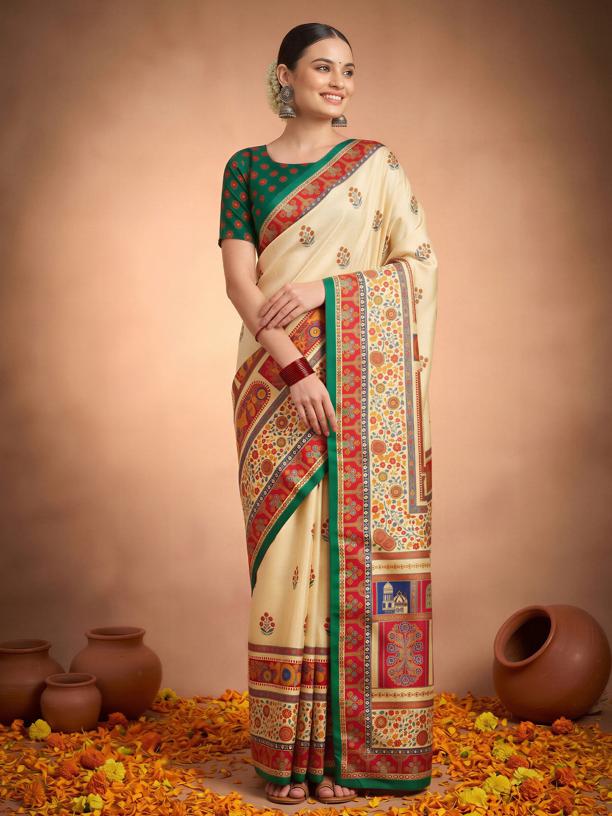 Woman wearing cream silk blend saree with metallic foil print work and dark green blouse