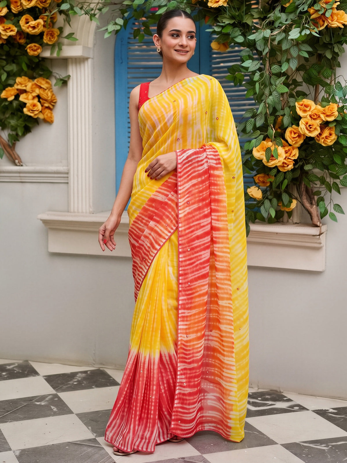 Yellow leheriya georgette saree with orange blouse piece