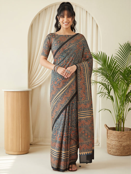 Woman wearing teal blue silk blend saree with traditional indian motif work and teal blue blouse