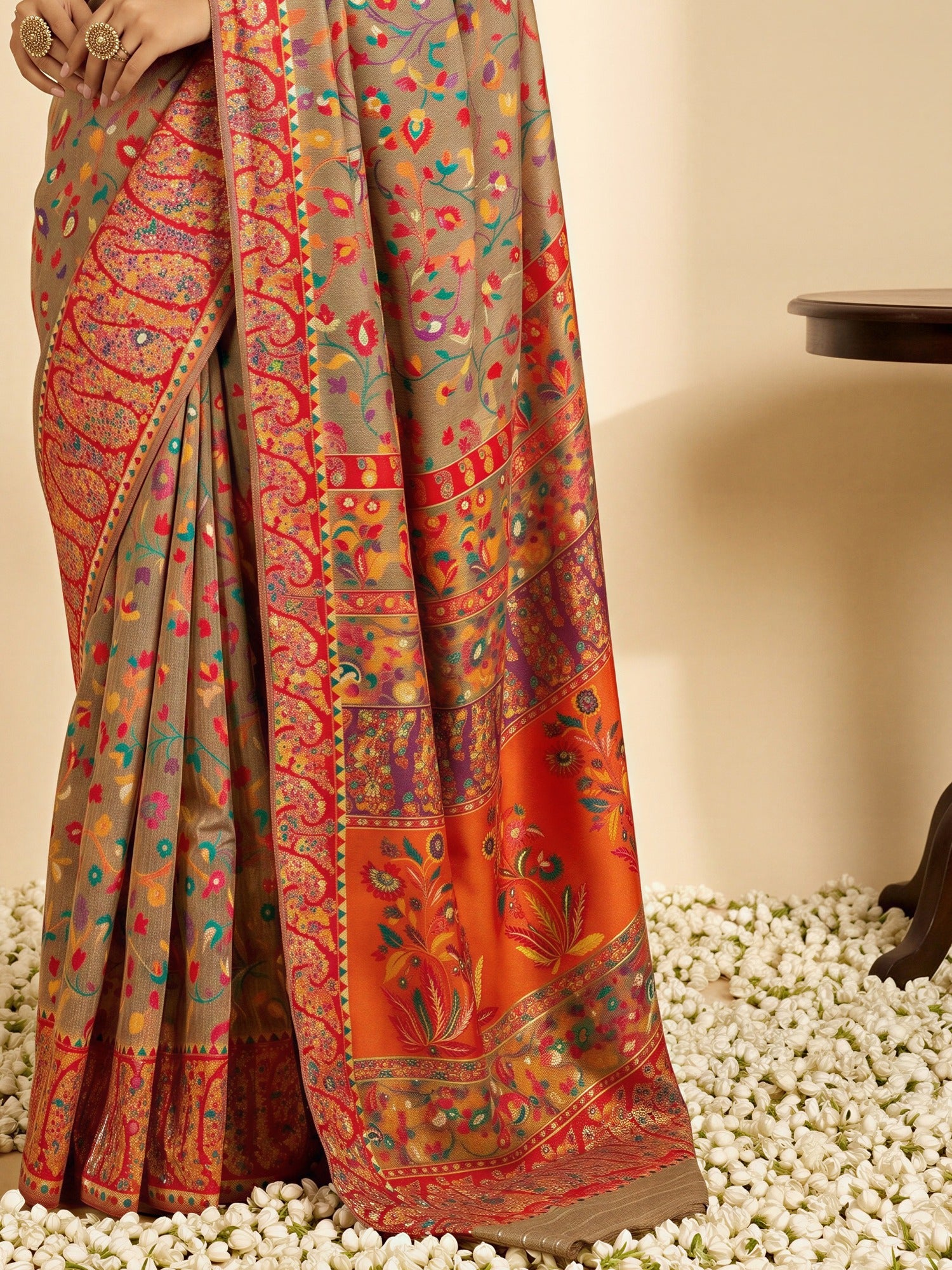 Pallu detail of beige cotton silk saree showing all-over floral design and woven design border