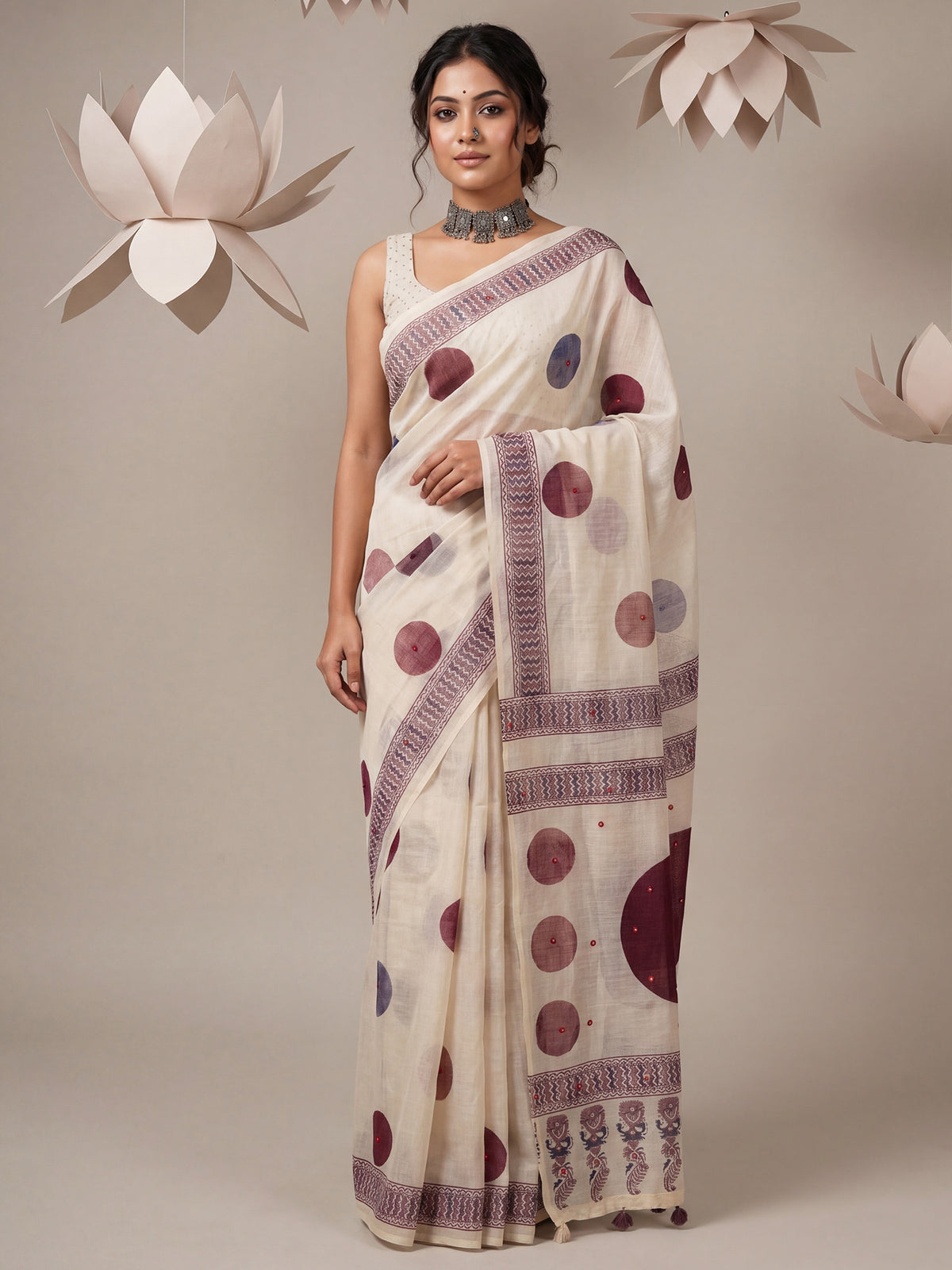 Woman wearing off white linen saree with traditional indian motif work and off white blouse