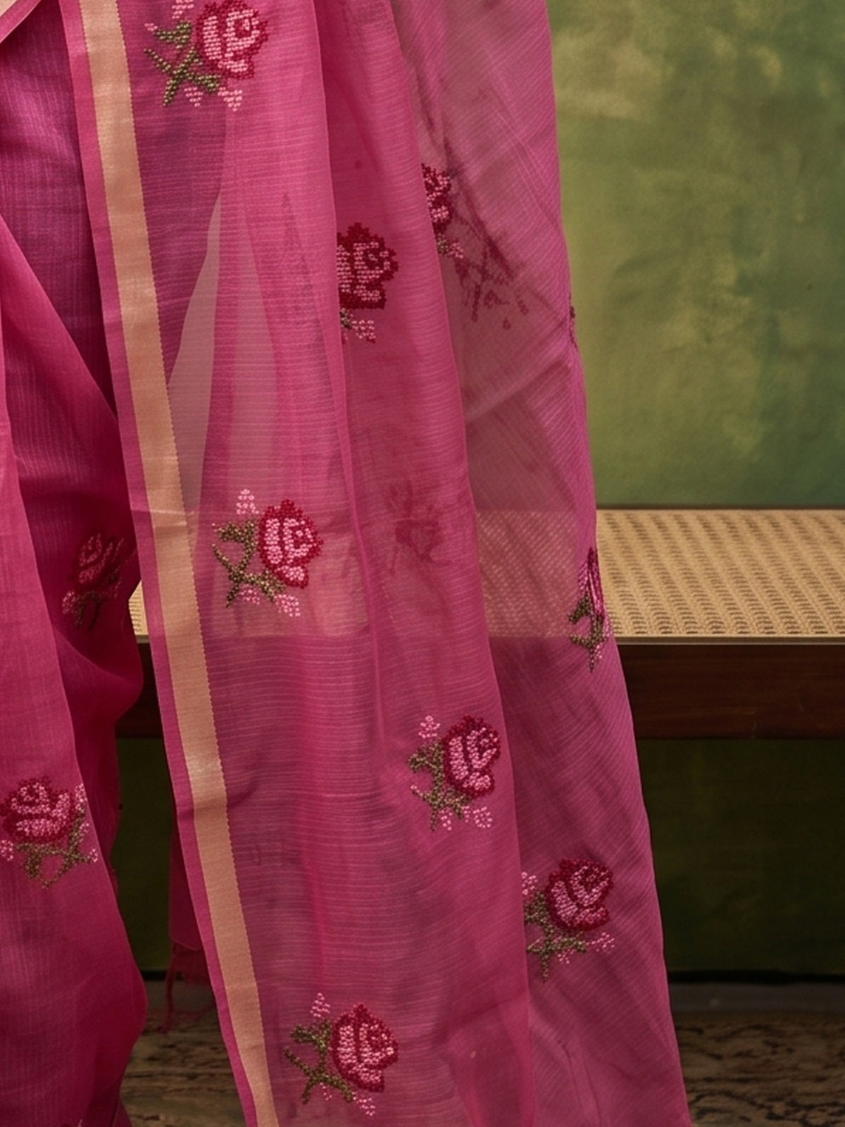 Pallu detail of magenta kota doria cotton saree showing embroidered motif work and zari border