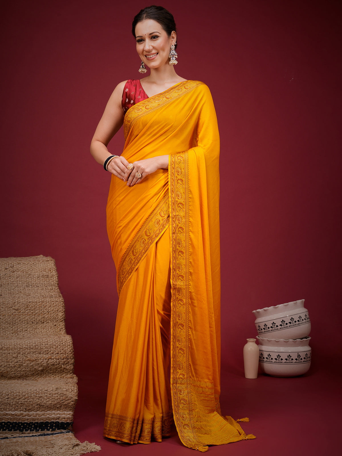 Woman wearing orange mysore silk saree with clean solid-tone finish and red blouse