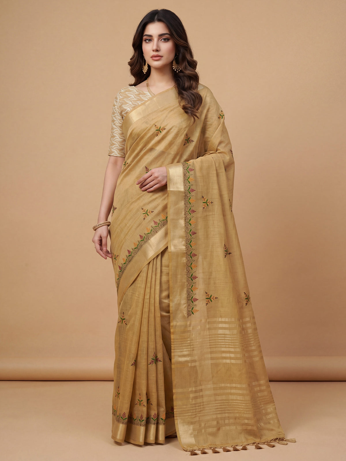Woman wearing beige cotton linen saree with embroidered motif work and beige blouse