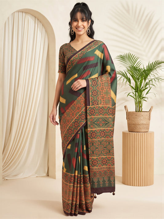 Woman wearing green silk blend saree with traditional indian motif work and green blouse