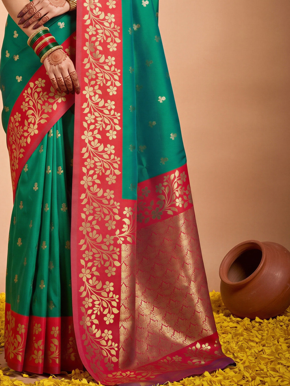 Pallu detail of green cotton blend saree showing all-over floral design and zari border