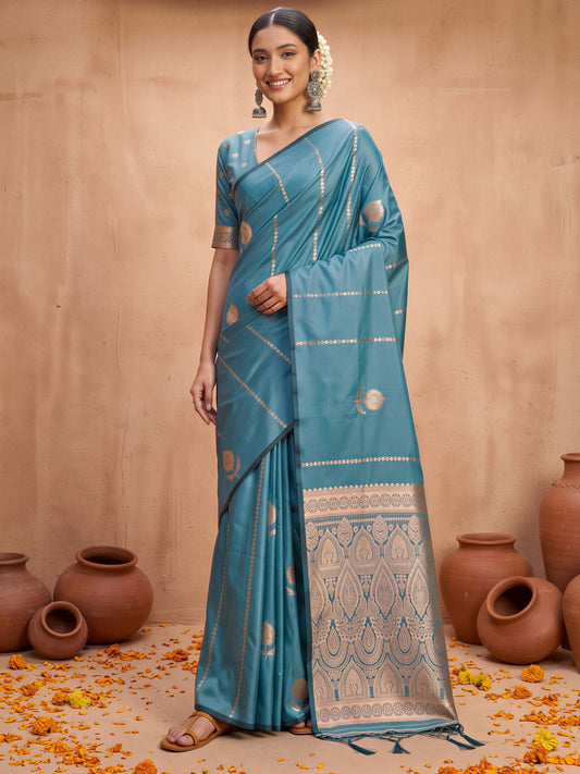 Woman wearing teal blue satin silk saree with traditional indian motif work and teal blue blouse