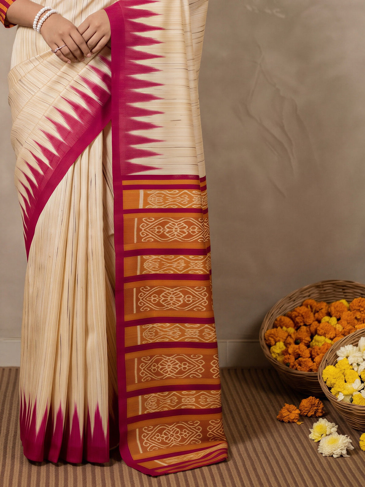 Pallu detail of beige bhagalpuri silk saree showing ikat resist-dyed pattern and printed border