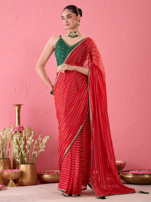 Woman wearing red viscose ready to wear saree with striped pattern design and green blouse