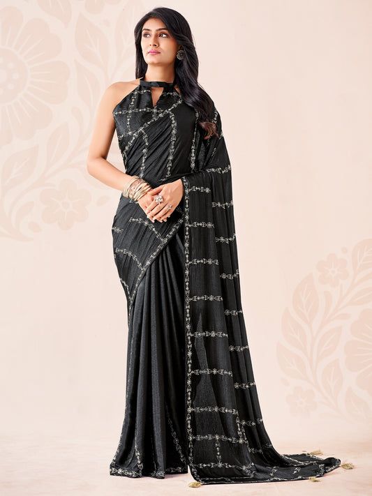Woman wearing black chiffon saree with ornamented surface design and black blouse