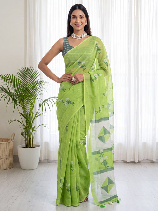 Woman wearing lime green cotton linen saree with all-over floral design and teal green blouse