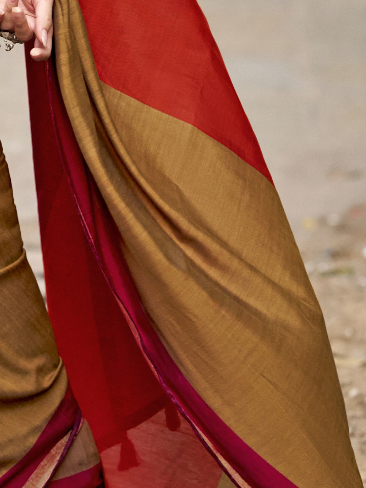 Pallu detail of red cotton blend saree showing colorblocked design and zari border