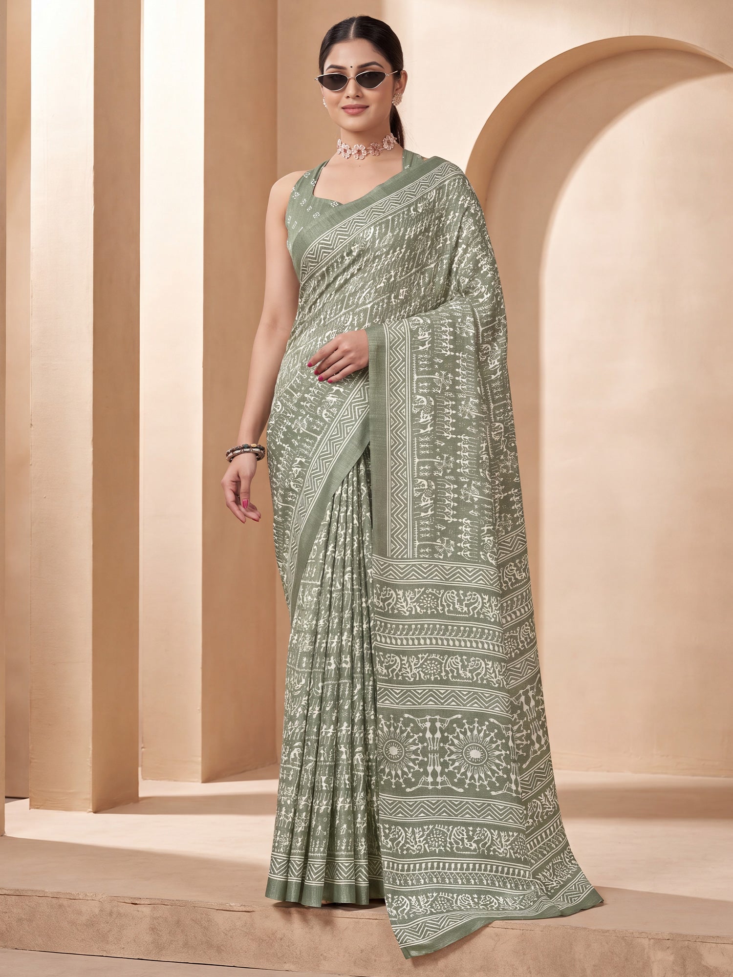 Woman wearing seagreen dola silk saree with warli folk-art figures and sea green blouse