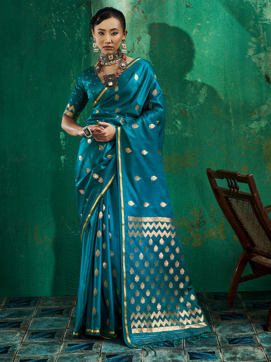 Woman wearing teal blue satin silk saree with zari butta (metallic motif) work and teal blue blouse
