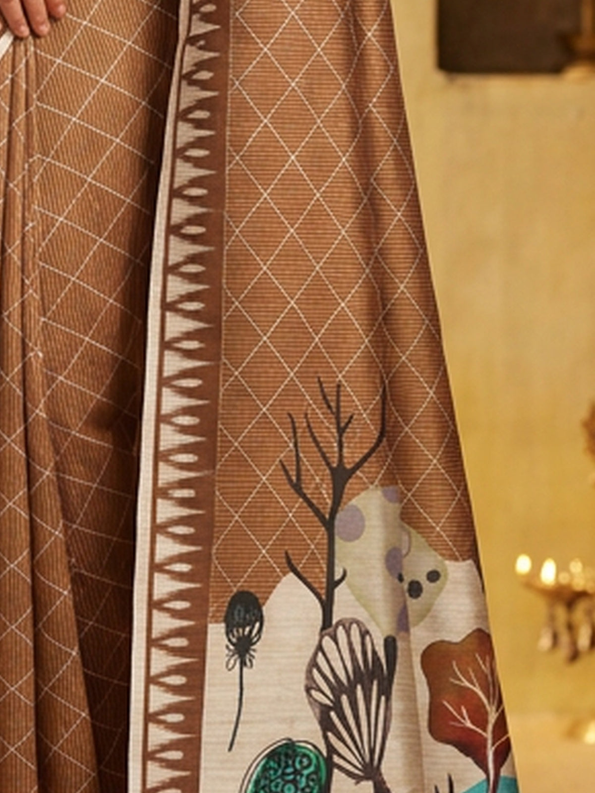 Pallu detail of light brown soft silk saree showing geometric pattern design and printed border