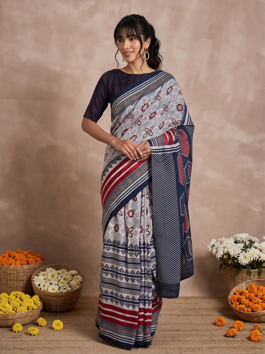 Woman wearing off white viscose silk saree with traditional indian motif work and navy blue blouse