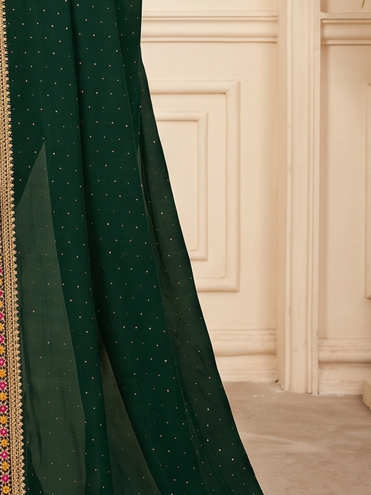 Pallu detail of green vichitra silk saree showing ornamented surface design and embellished border