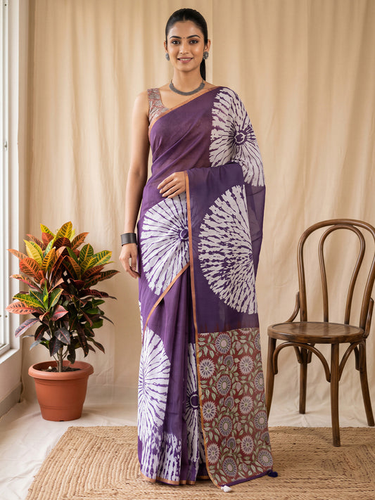 Woman wearing purple cotton blend saree with shibori resist-dye pattern and rust blouse