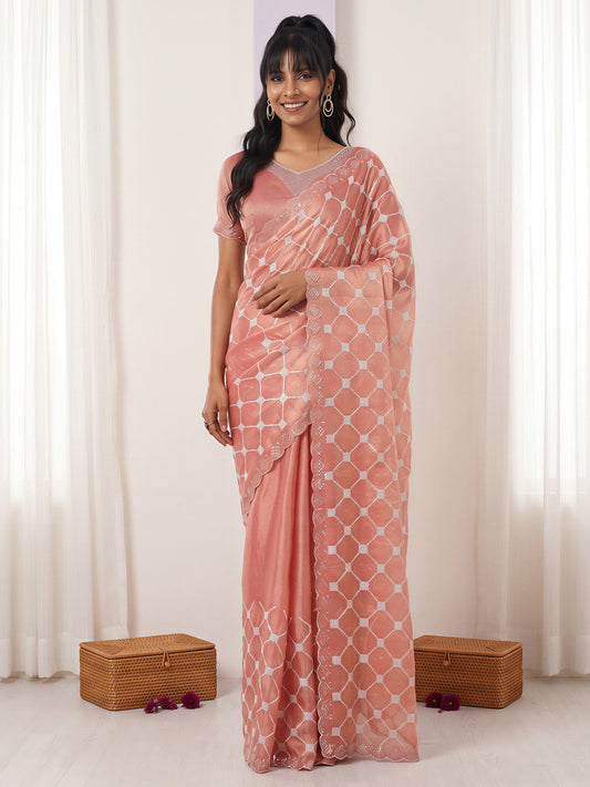 Woman wearing peach chiffon saree with embroidered motif work and peach blouse