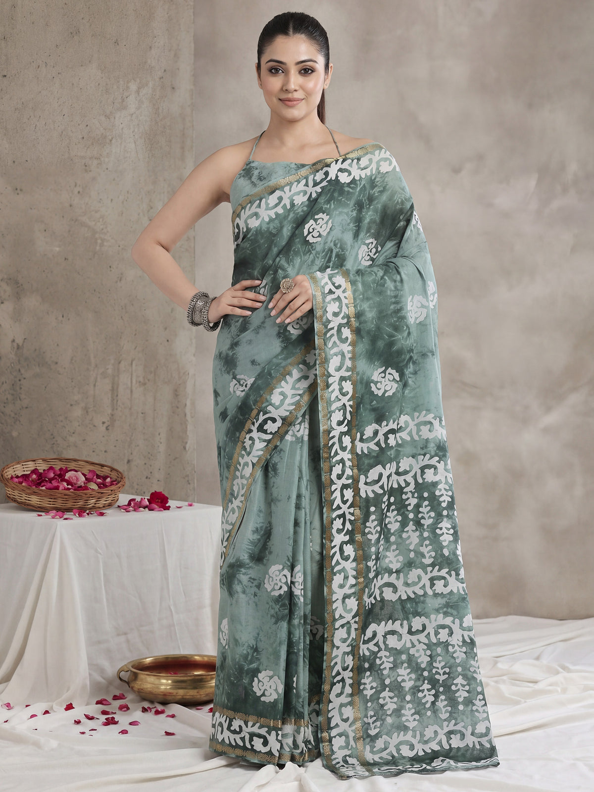 Woman wearing sea green cotton saree with shibori resist-dye pattern and sea green blouse