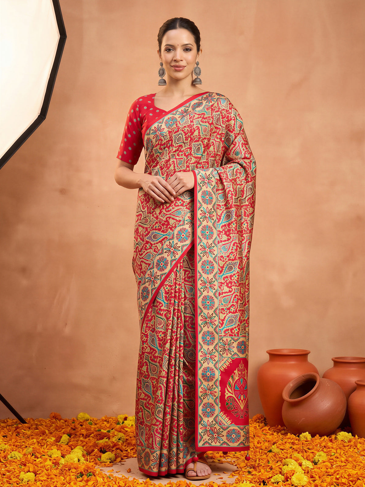 Woman wearing assorted silk blend saree with metallic foil print work and red blouse