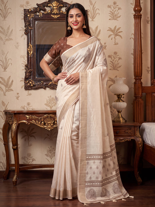 Woman wearing white satin silk saree with traditional indian motif work and brown blouse
