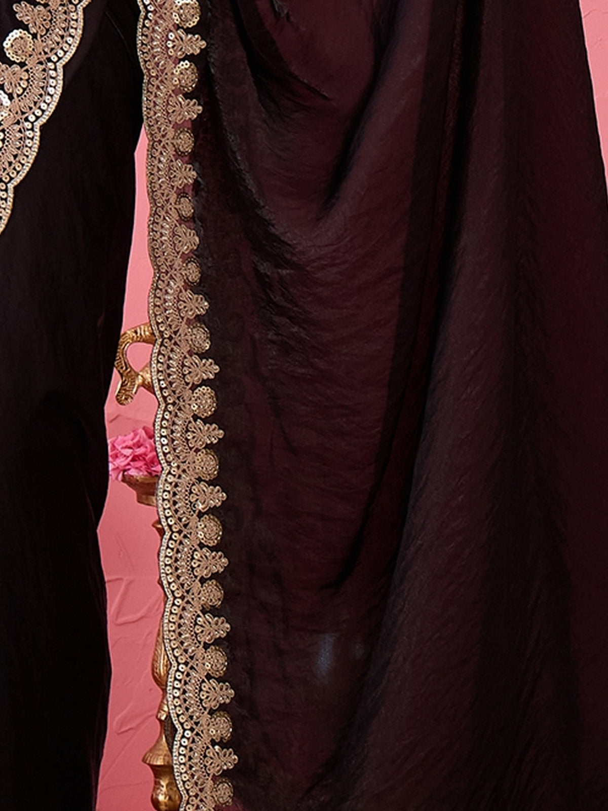 Pallu detail of black satin saree showing ornamented surface design and zari border
