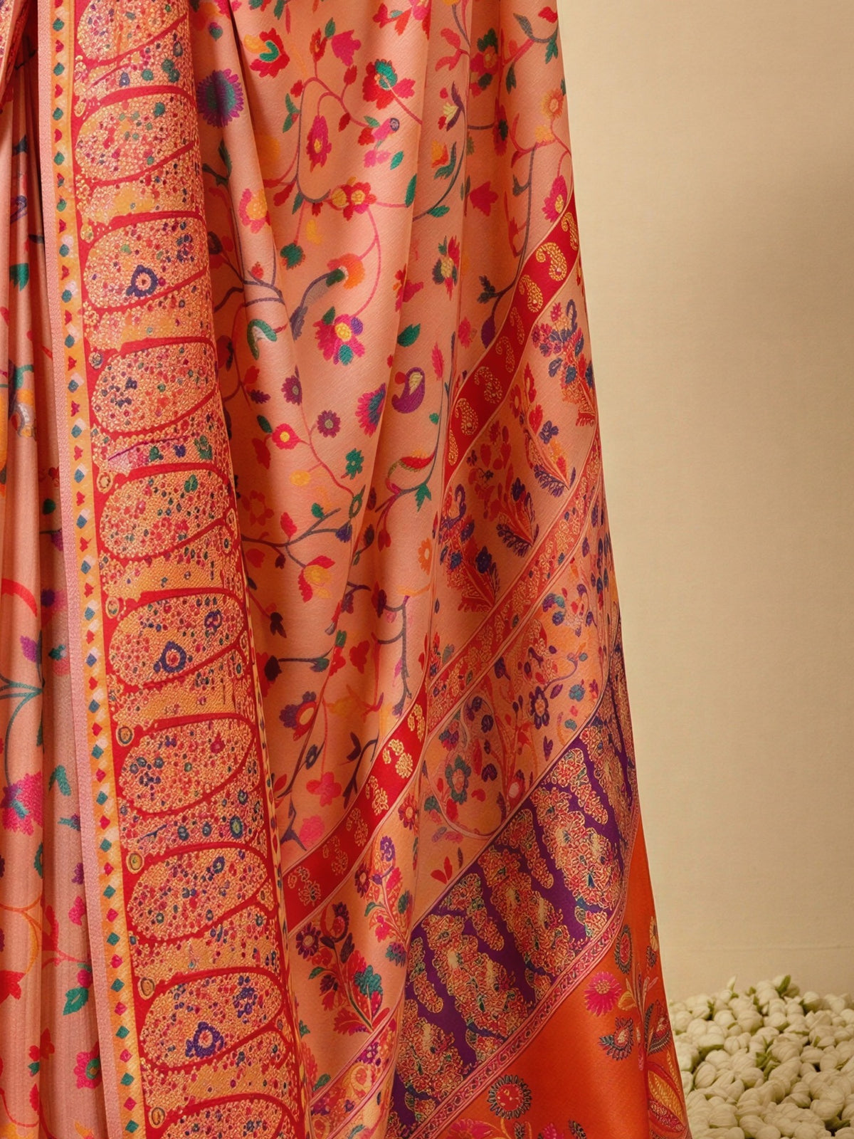 Pallu detail of peach cotton silk saree showing all-over floral design and woven design border