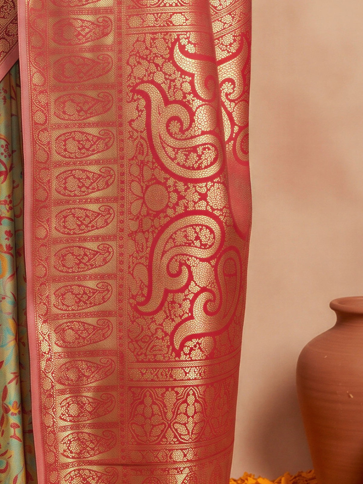 Pallu detail of sea green silk blend saree showing traditional indian motif work and zari border