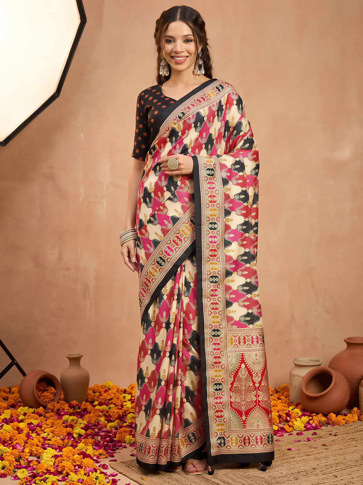 Woman wearing black silk blend saree with metallic foil print work and black blouse