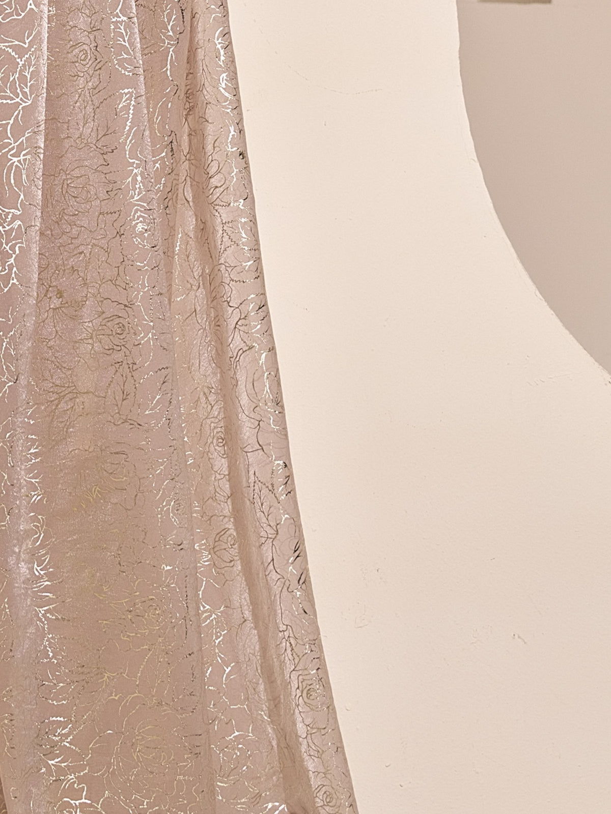 Pallu detail of champagne satin silk saree showing metallic foil print work and embellished border