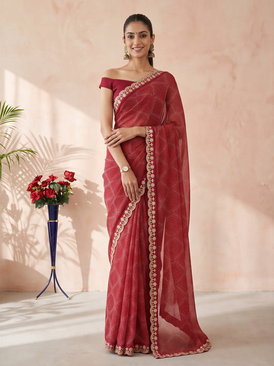 Woman wearing pink georgette saree with bandhani tie-dye dot work and pink blouse