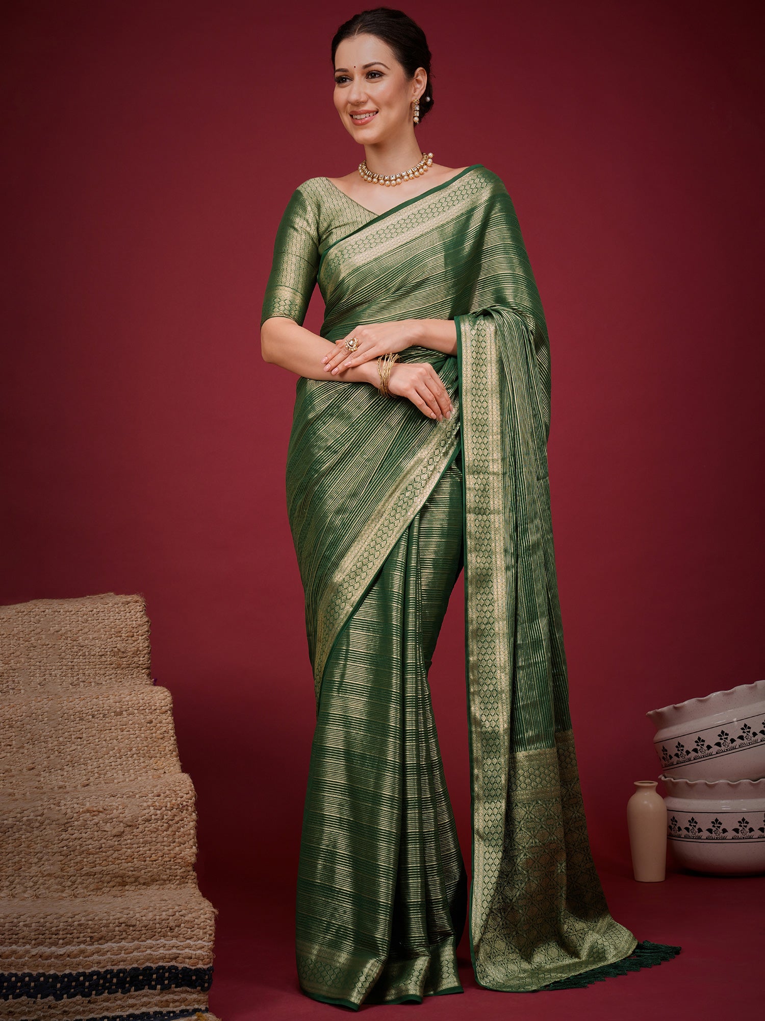 Woman wearing green viscose silk saree with striped pattern design and green blouse