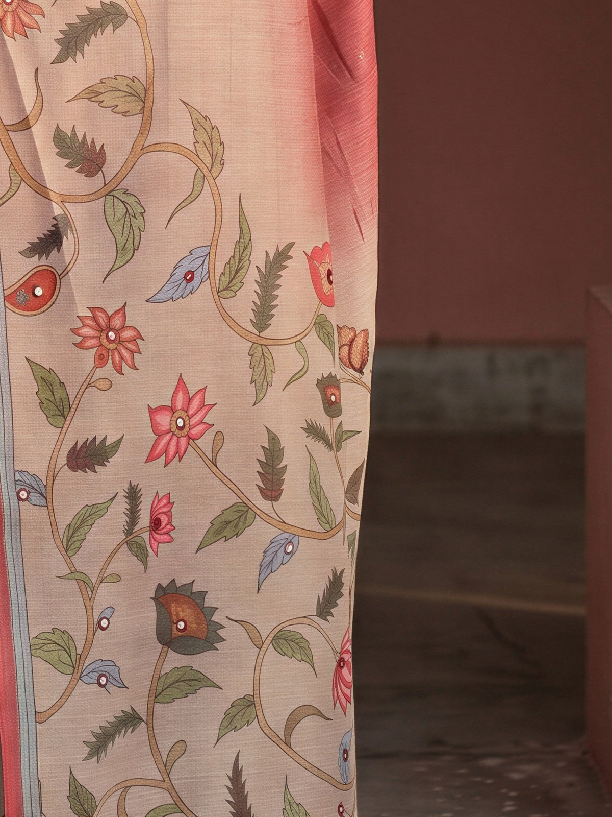 Pallu detail of maroon linen blend saree showing kalamkari narrative motif work and printed border