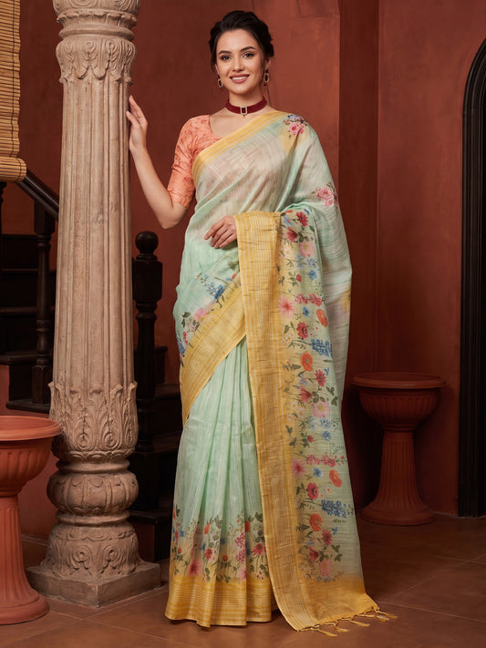 Woman wearing light blue tussar silk saree with all-over floral design and orange blouse