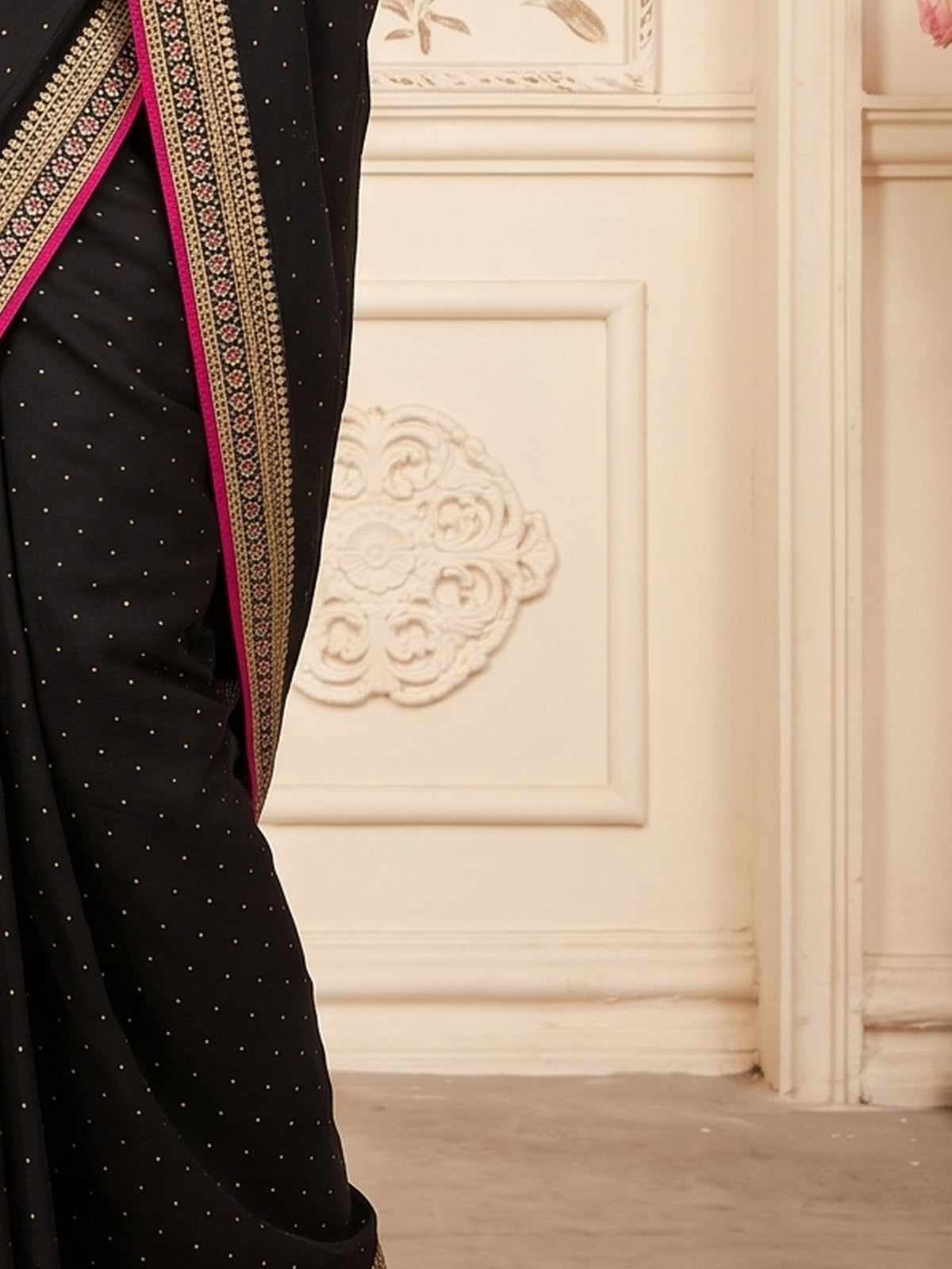 Pallu detail of black vichitra silk saree showing ornamented surface design and embellished border