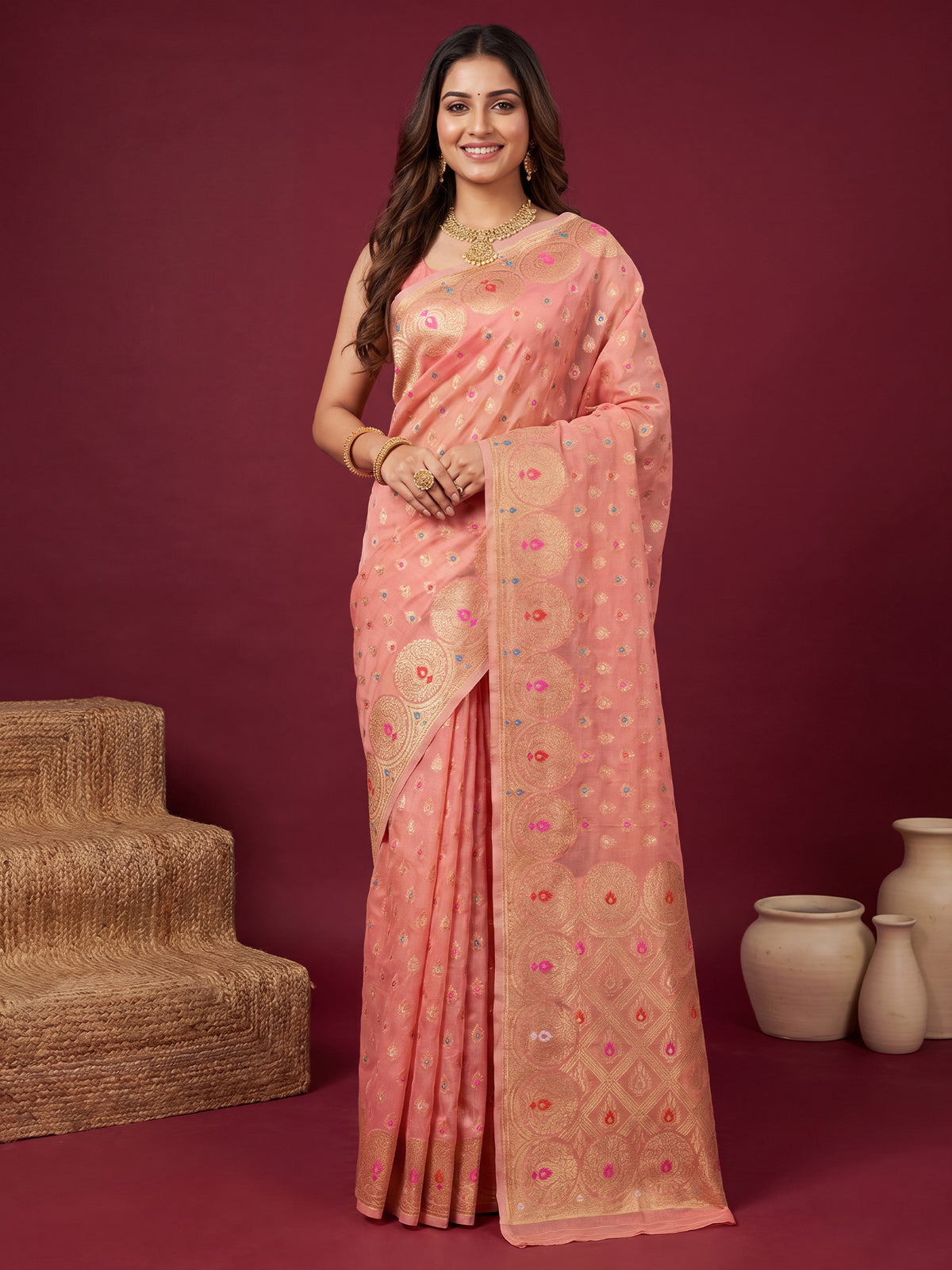 Woman wearing pink silk blend saree with zari butta (metallic motif) work and pink blouse