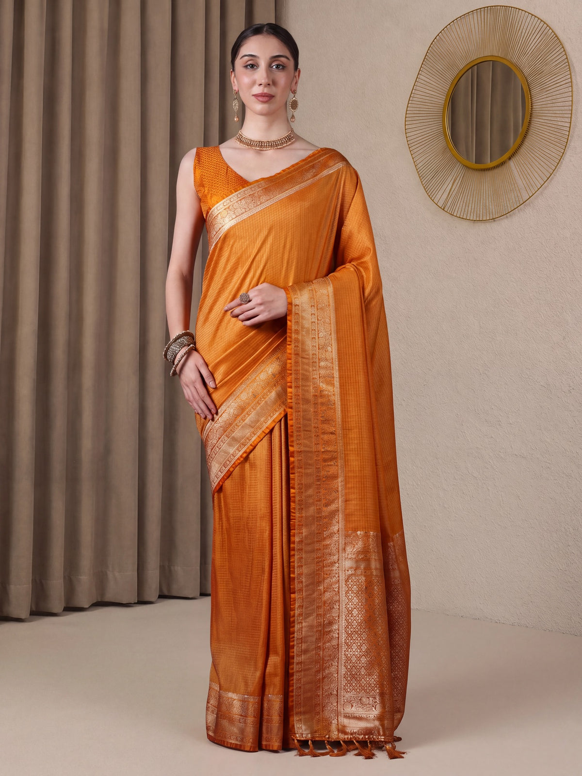 Woman wearing mustard banarasi silk saree with checked pattern design and mustard blouse