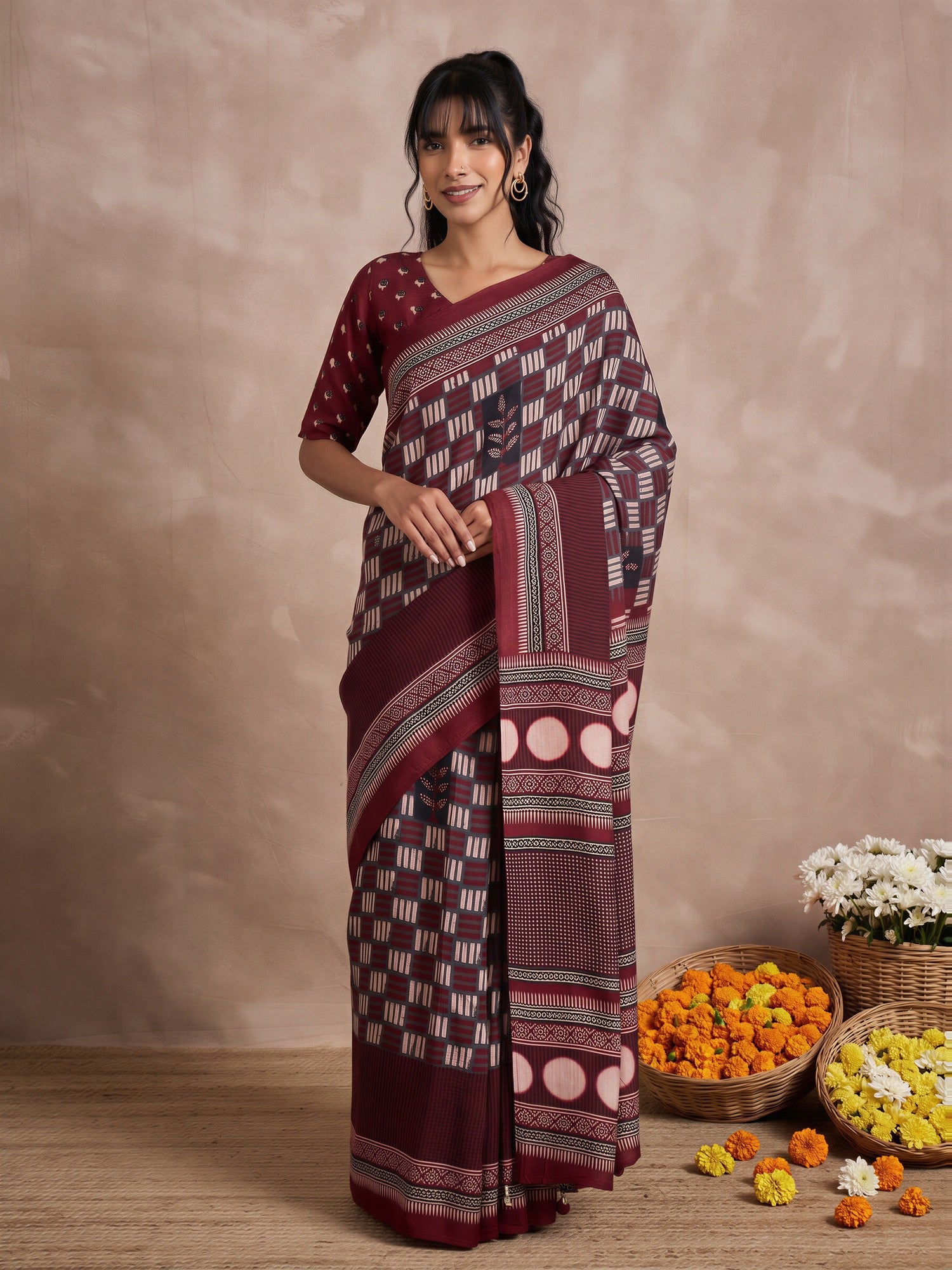Woman wearing maroon viscose silk saree with traditional indian motif work and maroon blouse