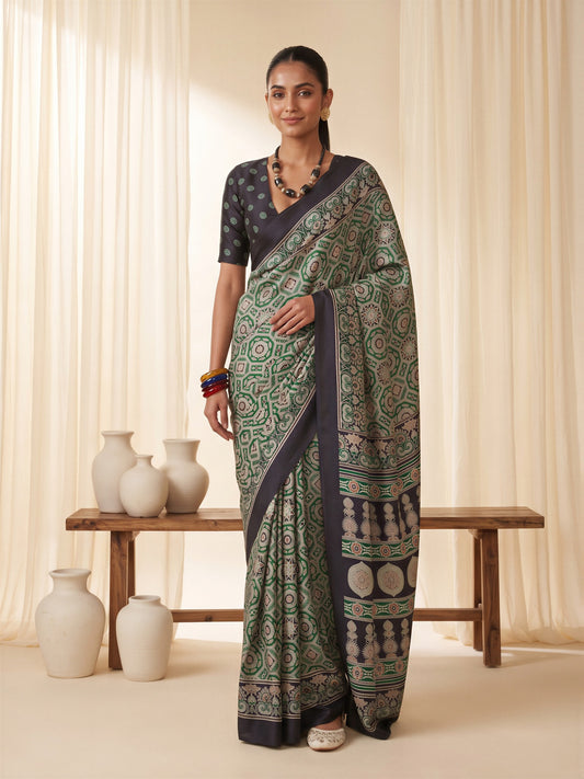 Woman wearing green crepe saree with ajrak block-print motif work and black blouse
