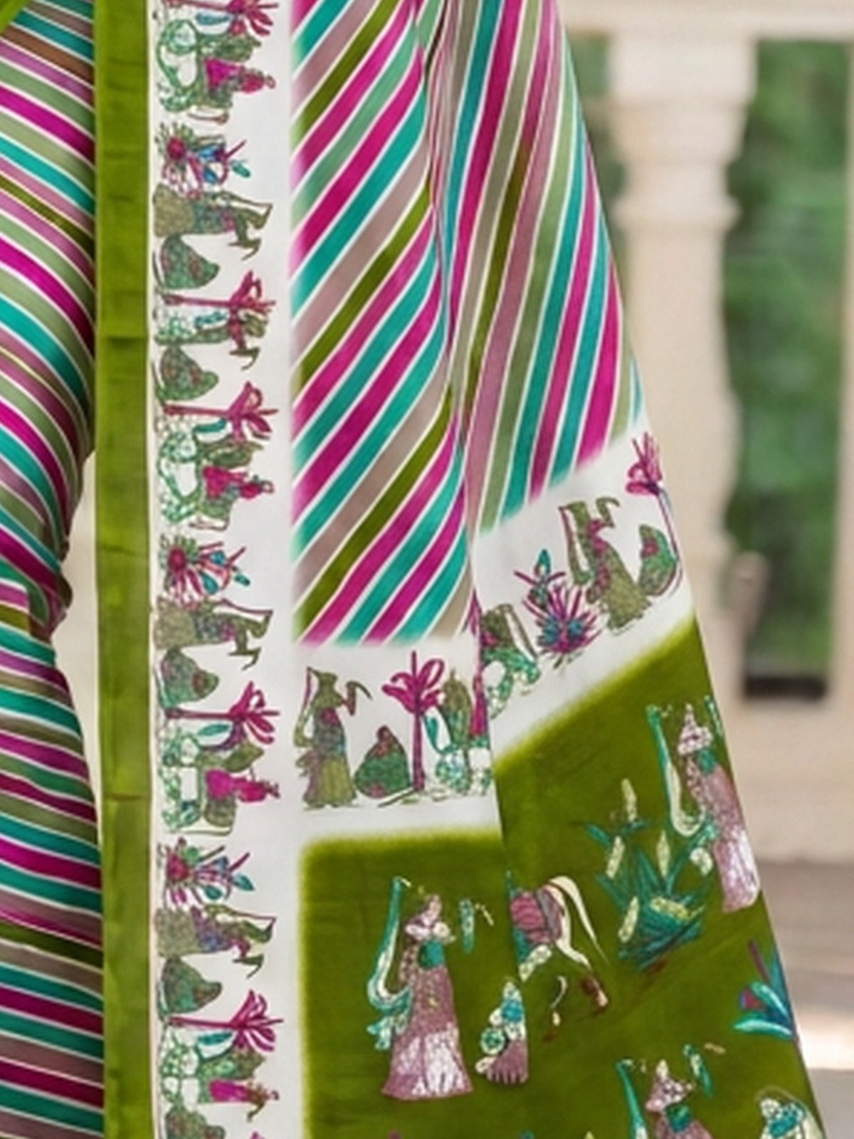 Pallu detail of light green crepe saree showing striped pattern design and printed border