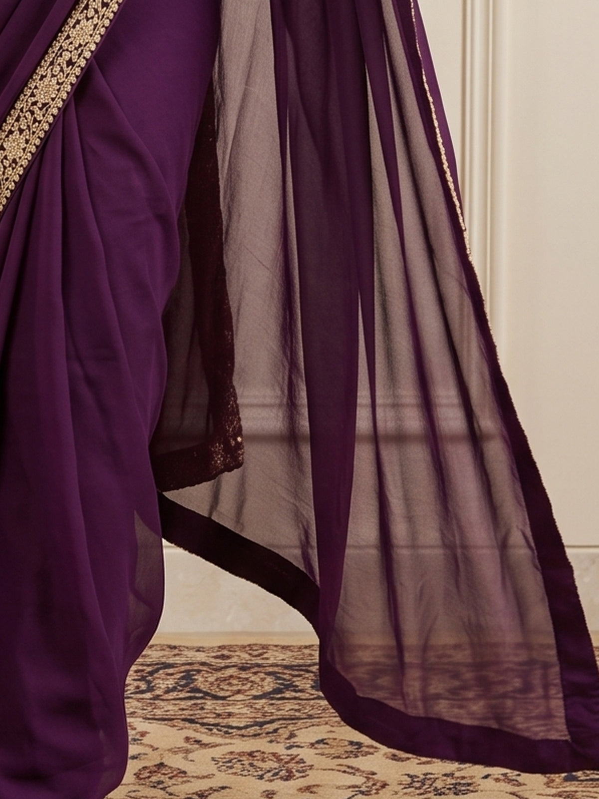 Pallu detail of magenta satin silk saree showing clean solid-tone finish and embellished border
