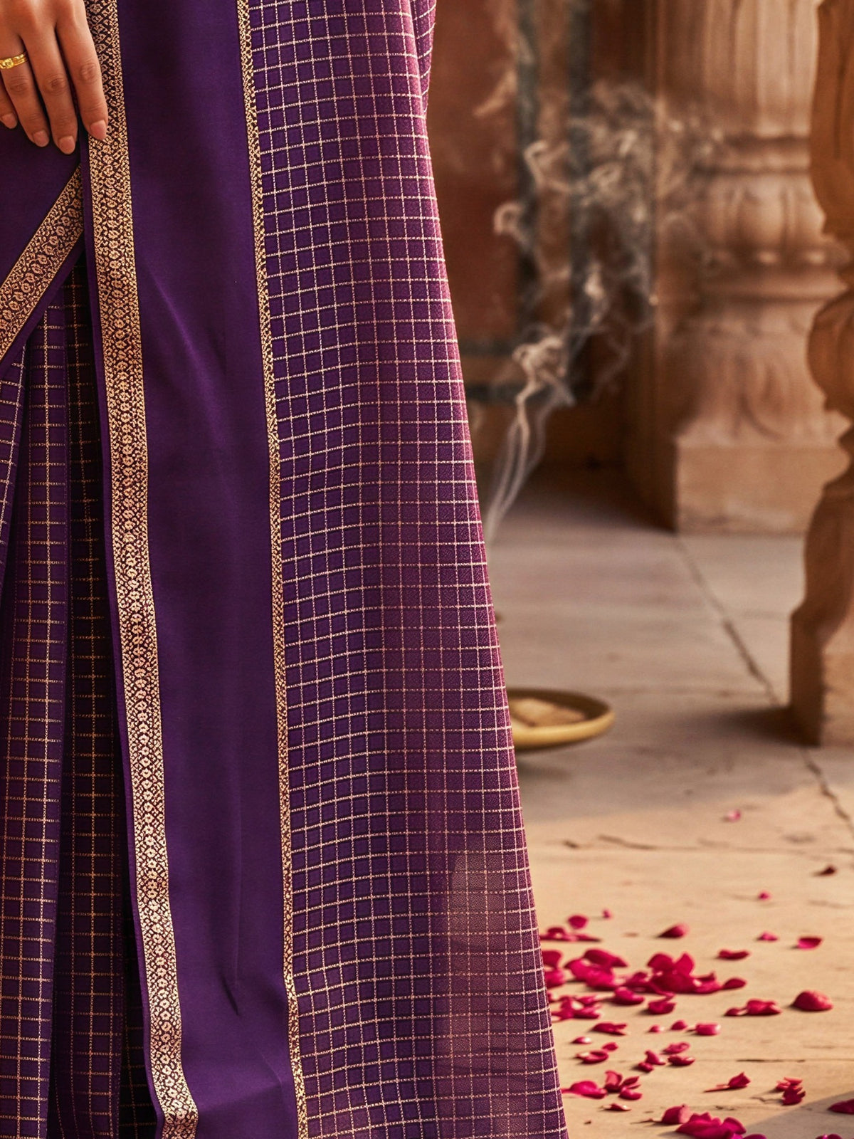 Pallu detail of purple viscose saree showing checked pattern design and zari border