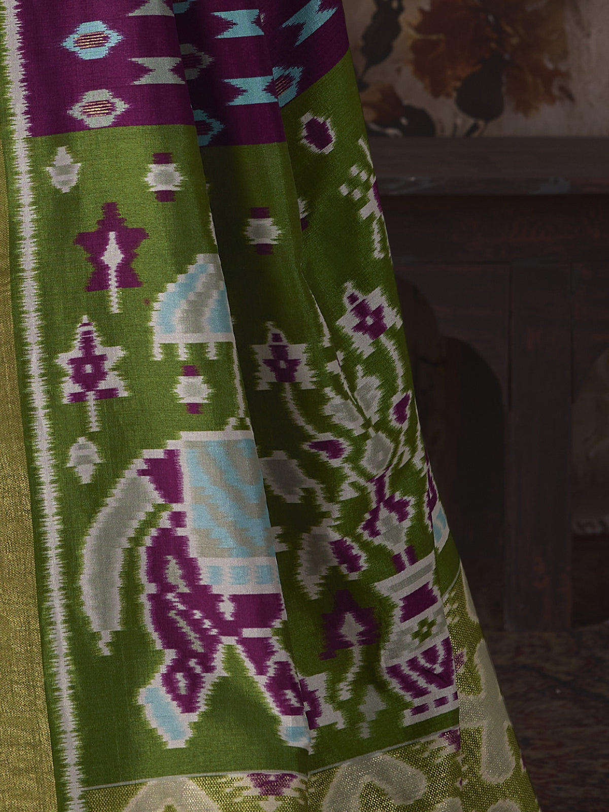 Pallu detail of purple silk blend saree showing ikat resist-dyed pattern and embellished border