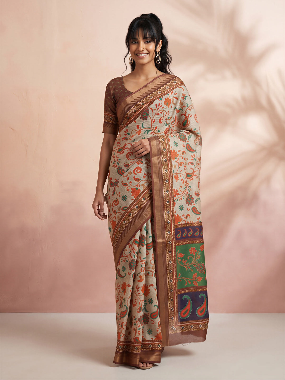 Woman wearing light brown cotton linen saree with traditional indian motif work and brown blouse