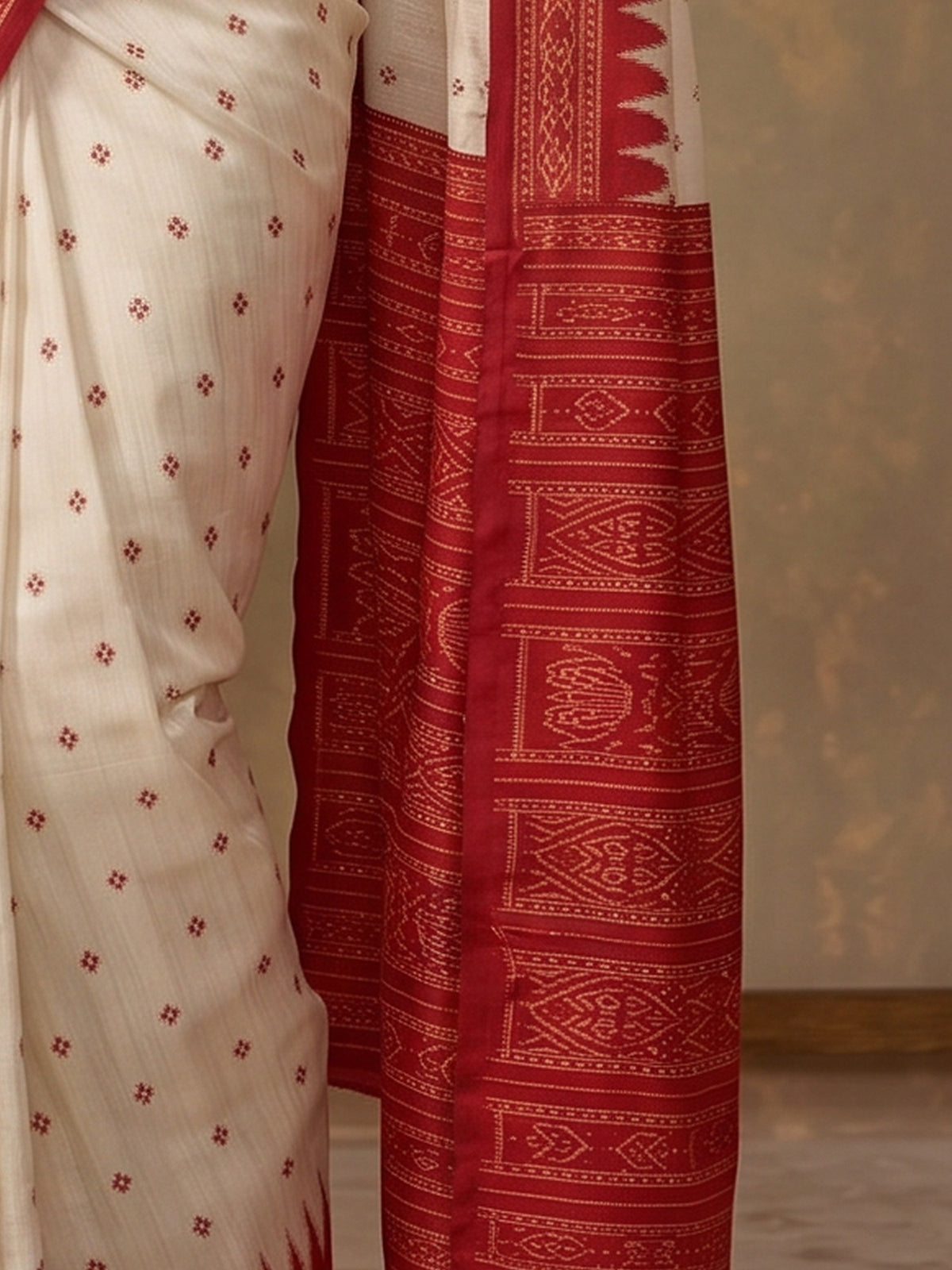 Pallu detail of off white tussar silk saree showing traditional indian motif work and printed border