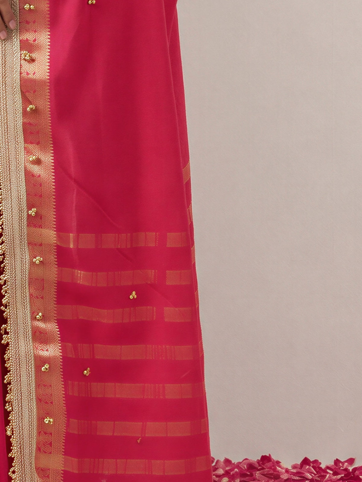 Pallu detail of pink soft silk saree showing woven motif design and zari border
